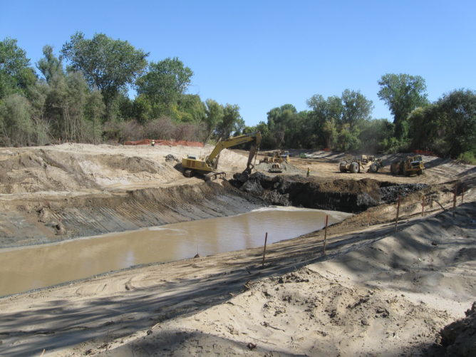 big puddle of water in middle of dirt