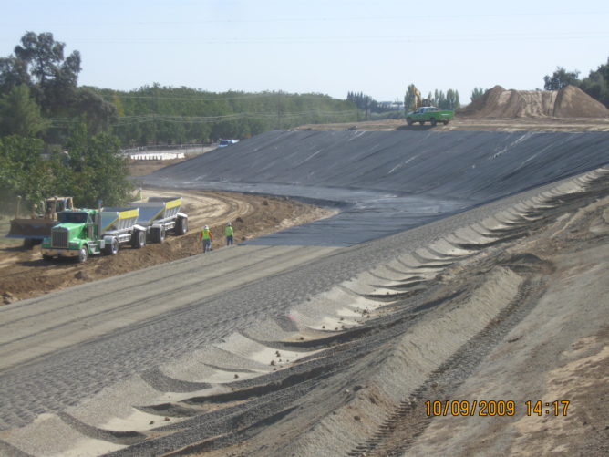 trucks around a tall hill of dirt