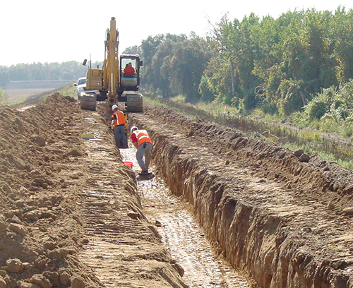 construction crane plowing through mud