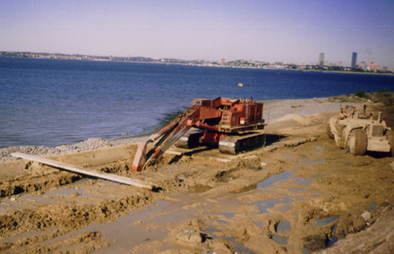 construction crane in mud at water's edge