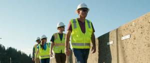 Men and women in hard hats walking along levees