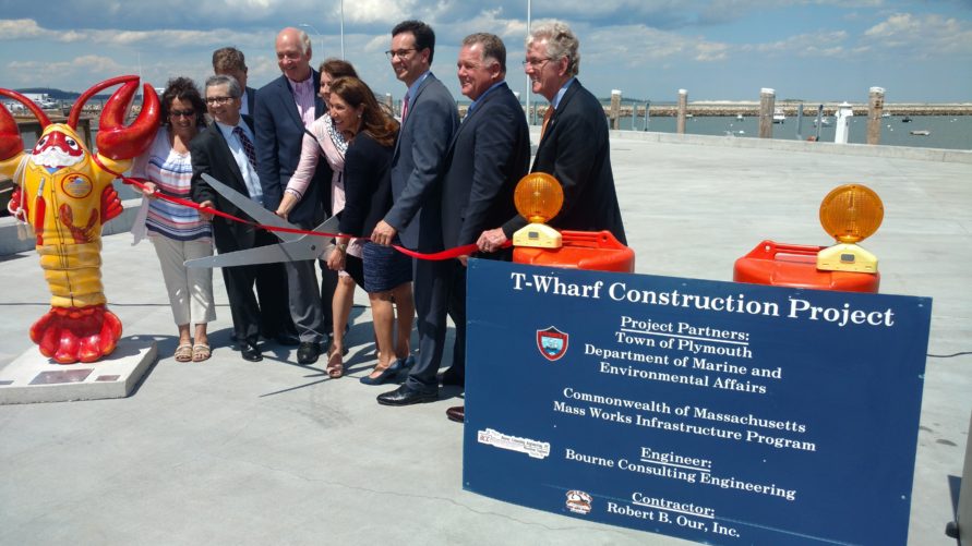 people cutting ribbon at T Wharf commercial pier