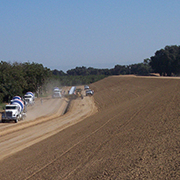 trucks driving on dirt at levee