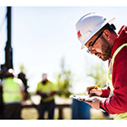 GEI employee with white hard hat taking notes