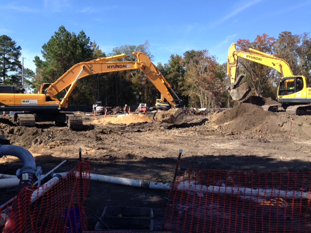 two construction cranes excavating