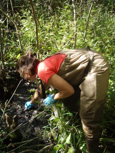 woman in overalls digging