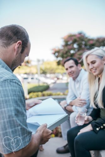 close-up of GEI employees sitting outside and looking at notes