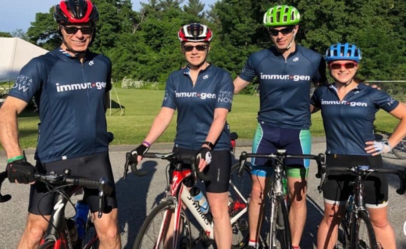 four people posing on bikes