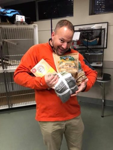 man carrying dog treats and towels