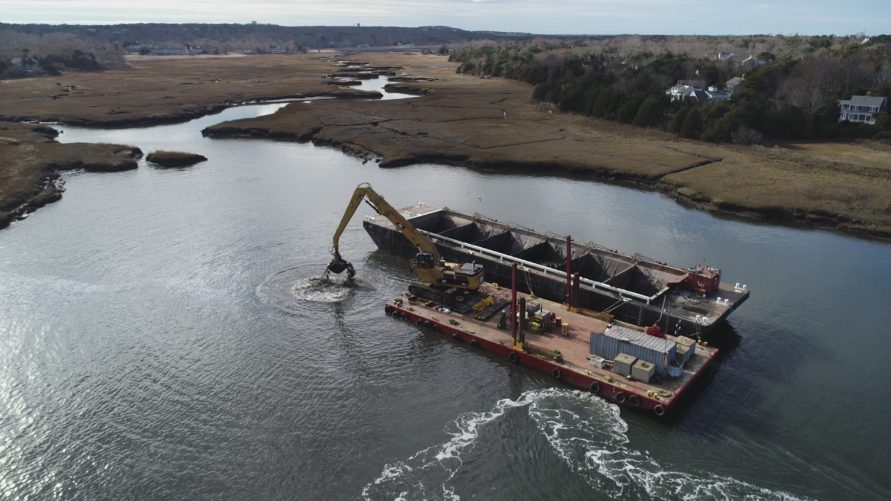 overhead view of construction crane doing dredging work in Sesuit Harbour