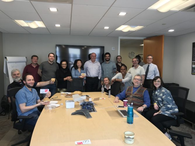 GEI team around table with pies