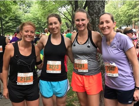 4 women wearing race bibs