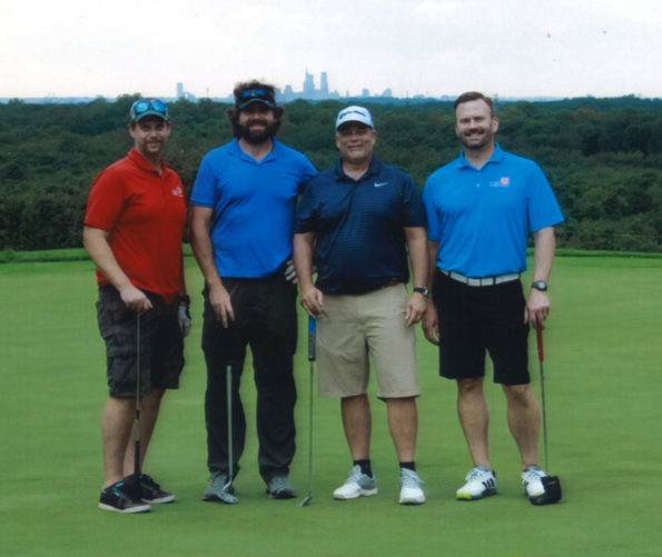 4 men on a golf course