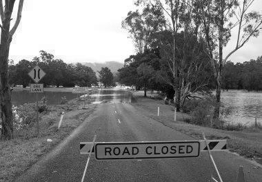 Road closed sign on flooded road