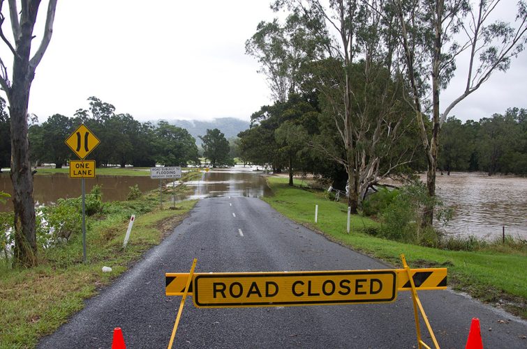 Road closed sign on flooded road