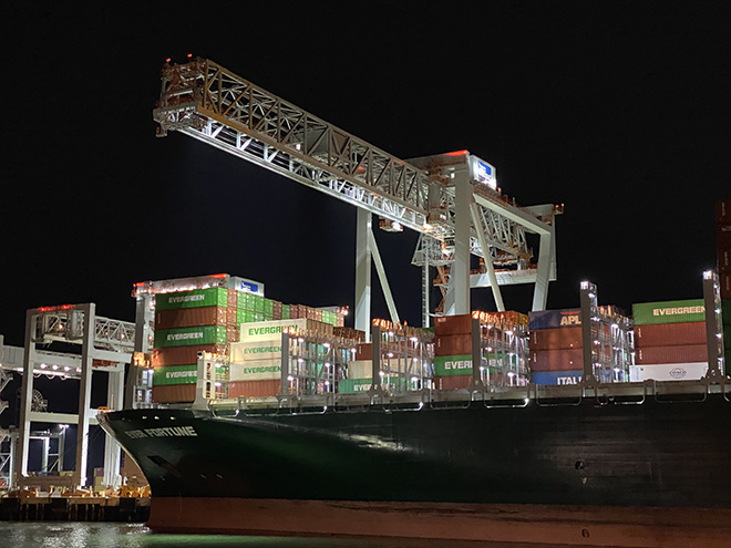 Container ship under crane in port