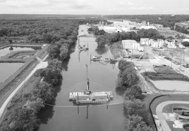 Large crane atop barge on water body