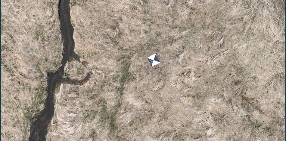 Aerial view of watercourse being surveyed by a drone