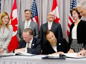 US and Canada officials signing documents