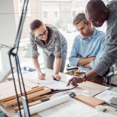 Discussion of three people around a desk