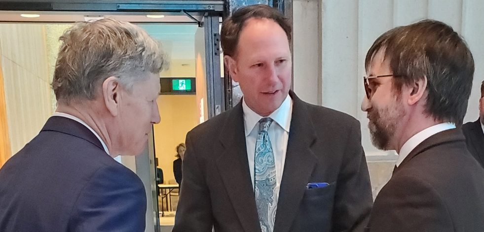 Men in suits having a discussion at a conference