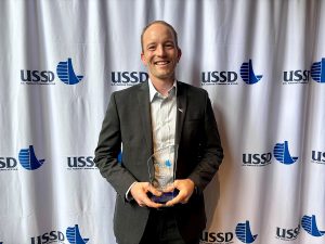Chris Krage holding award