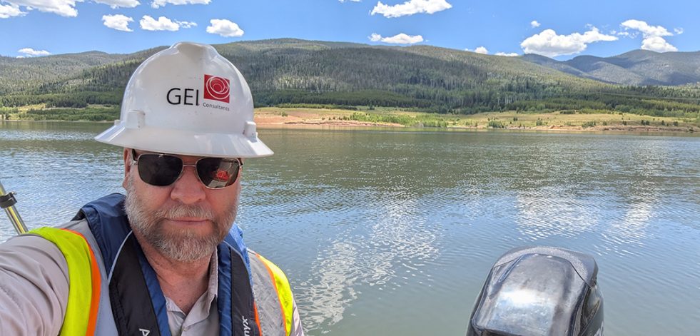 Man in boat wearing hard hat