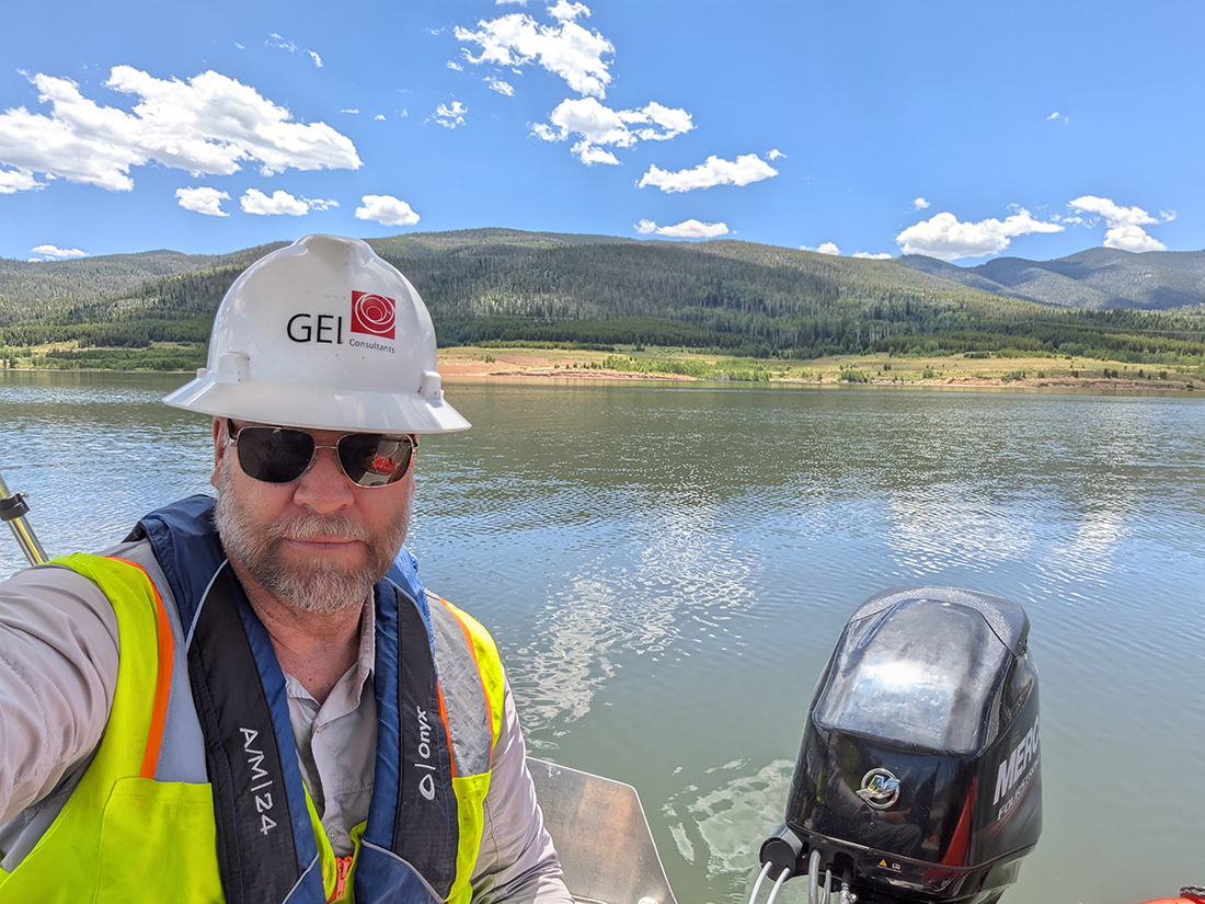 Man in boat wearing hard hat