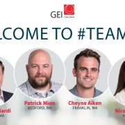 Portrait of Three Men and One Woman Under Welcome Message