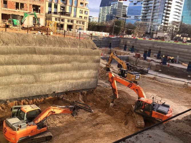 Heavy equipment working on foundations of building